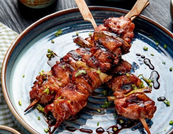 top-view-grilled-chicken-skewers-with-soy-sauce-plate-wood1